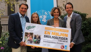 O'Learys styrelse håller upp en skylt där de ger en miljon skolmåltider till Svenska FN-förbundets arbete Skolmat