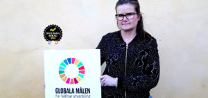 Generalsekreterare Petra Hallebrant håller en skylt om de Globala målen